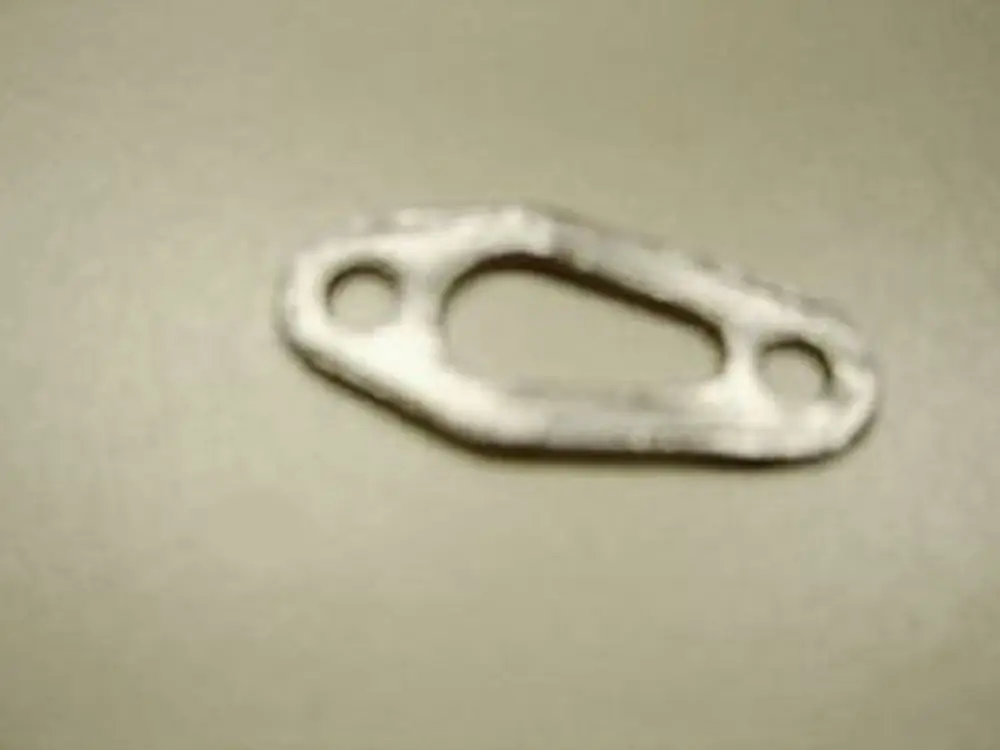 Dichtungselement von Remeha, mit zwei Bohrungen und einer ovalen Form, auf neutralem Hintergrund.